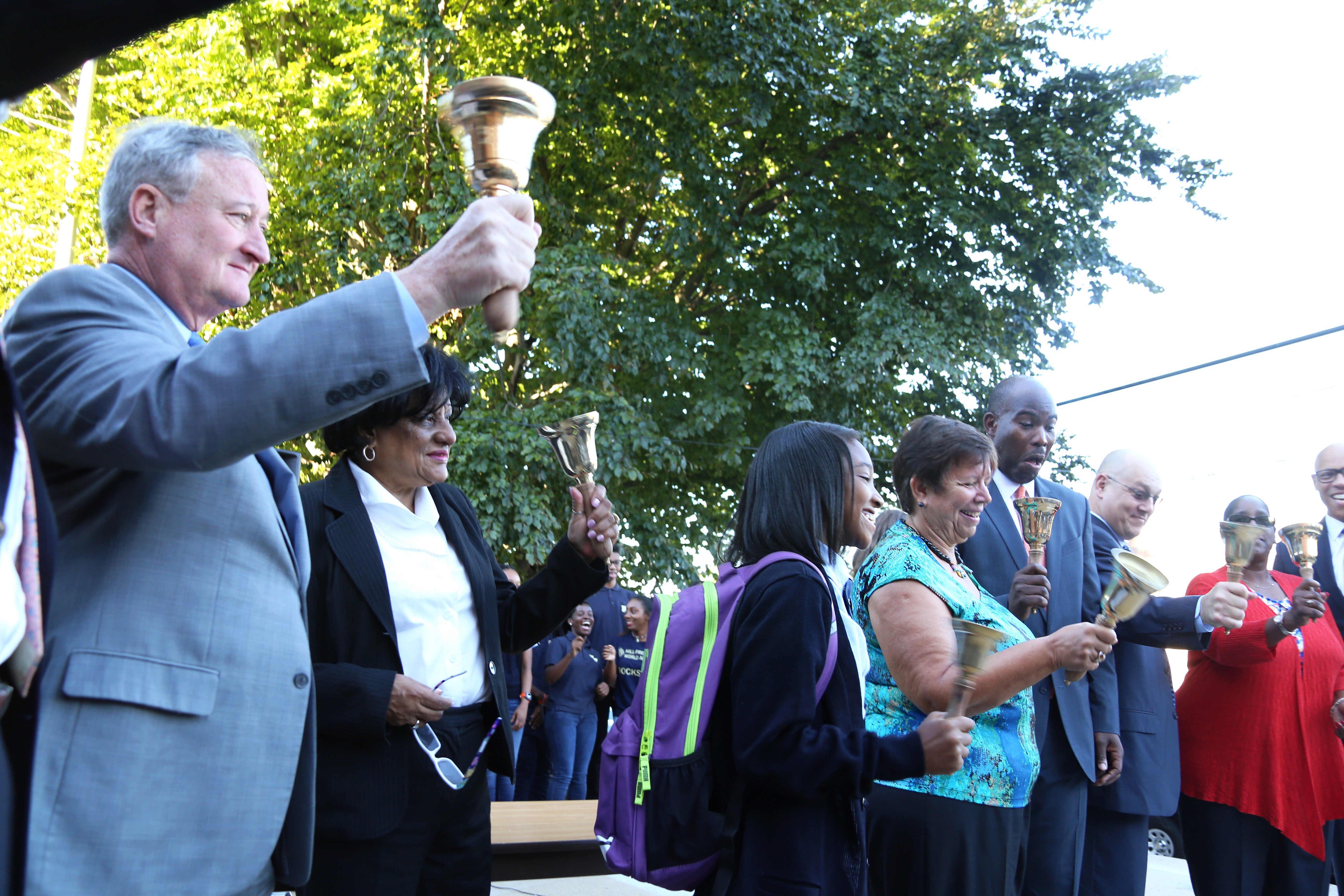 Mayor Kenney rings a big golden bell alongside City Council members, teachers, and City officials.